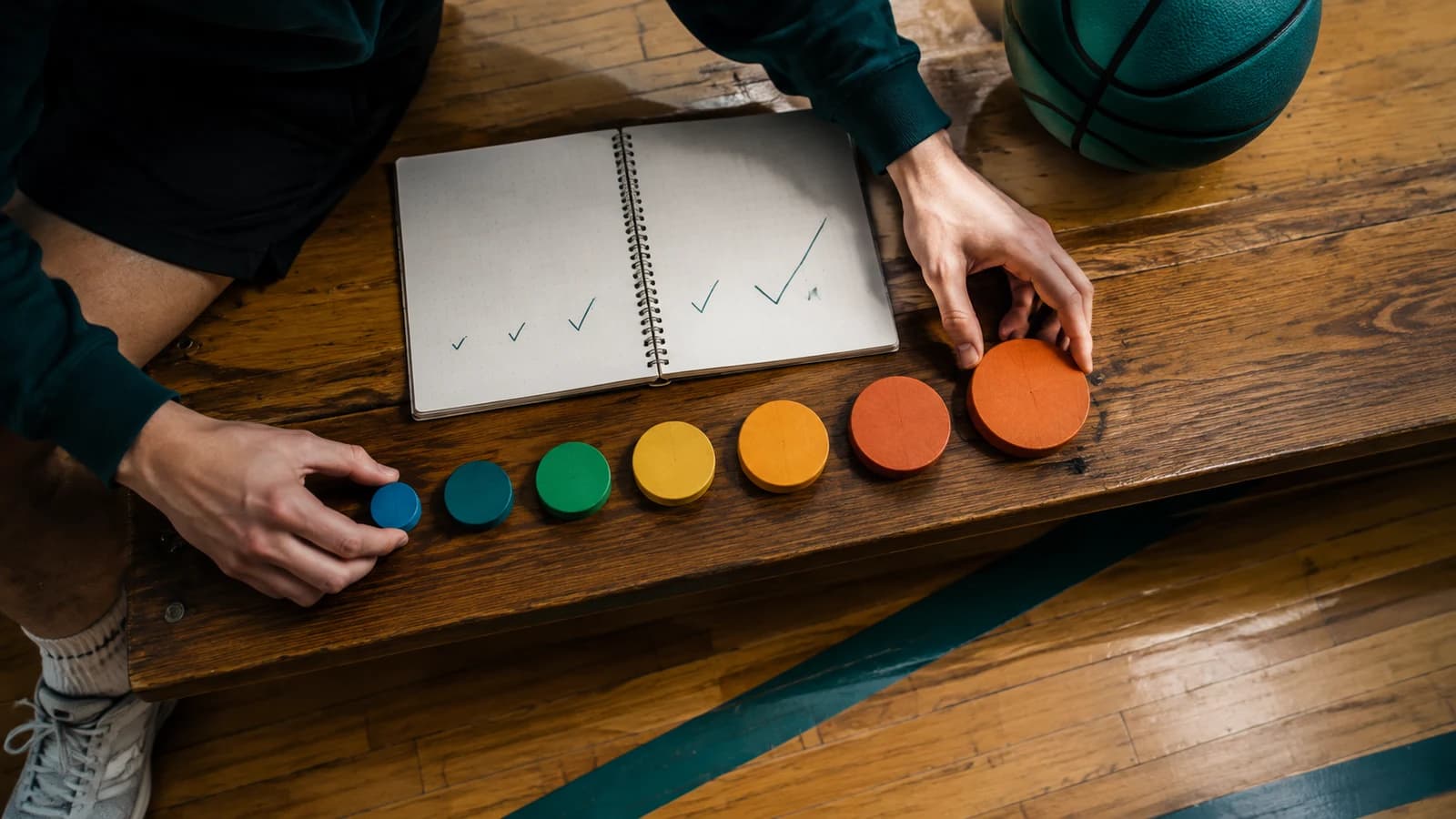 Overhead view of a student arranging blank colored tokens from smallest to largest